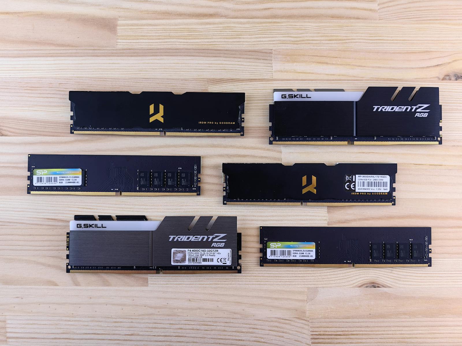 Top view of various RAM sticks arranged on a wooden surface, showcasing computer memory technology.